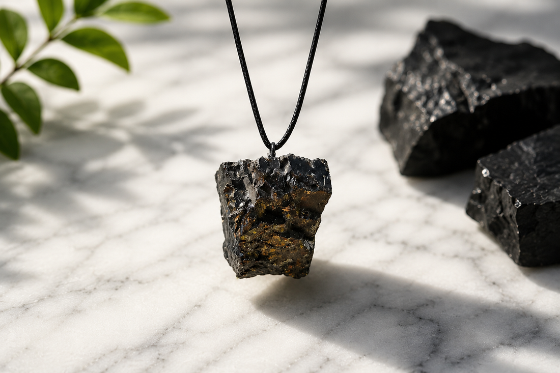 elite raw shungite pendant hanging on marble background 