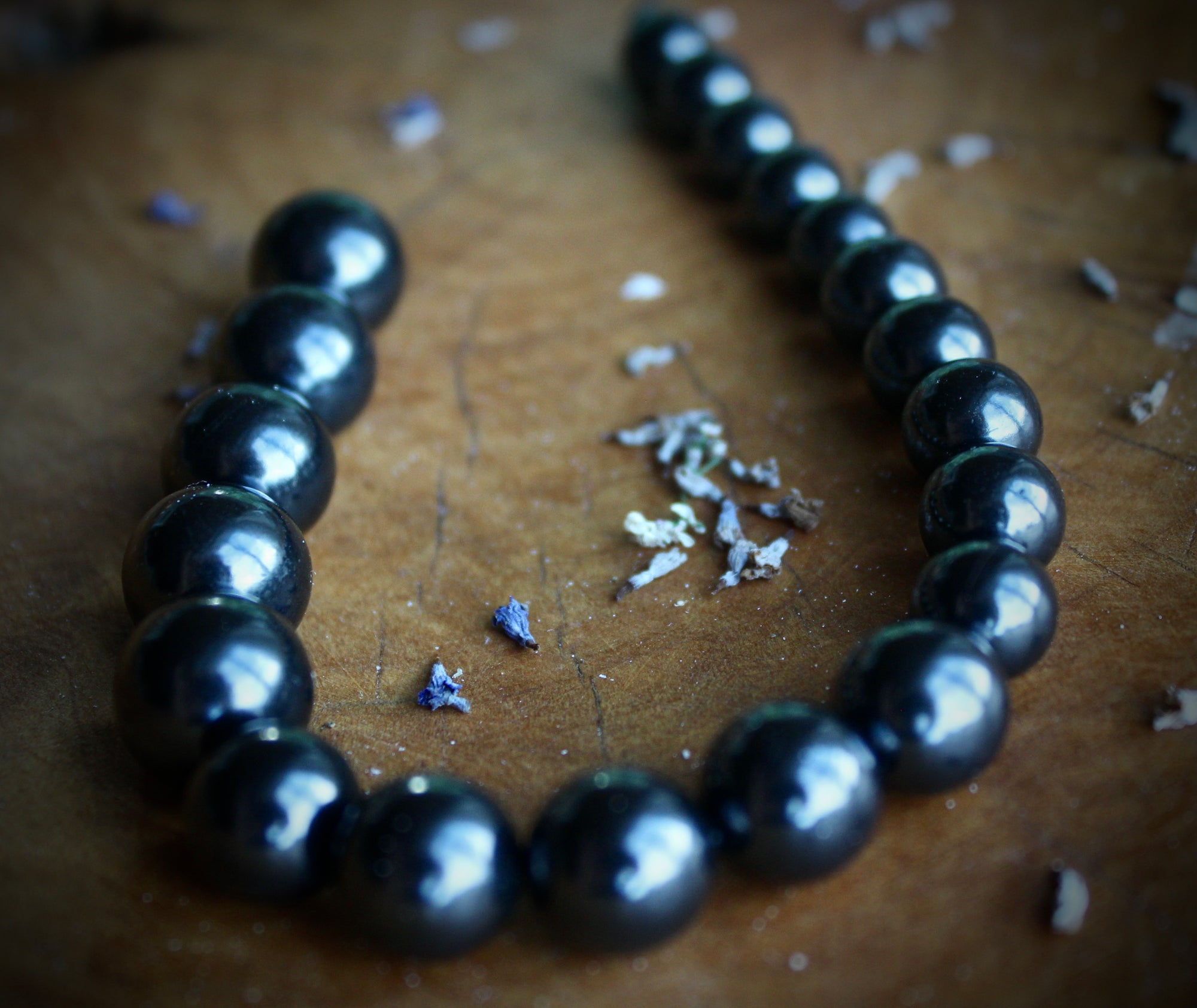 "An image showcasing a string of Shungite beads, ranging from 6mm to 12mm in size, each meticulously crafted and gleaming with a natural luster. These beads emanate an aura of spiritual energy and earthly beauty, perfect for creating unique and transformative jewelry pieces."