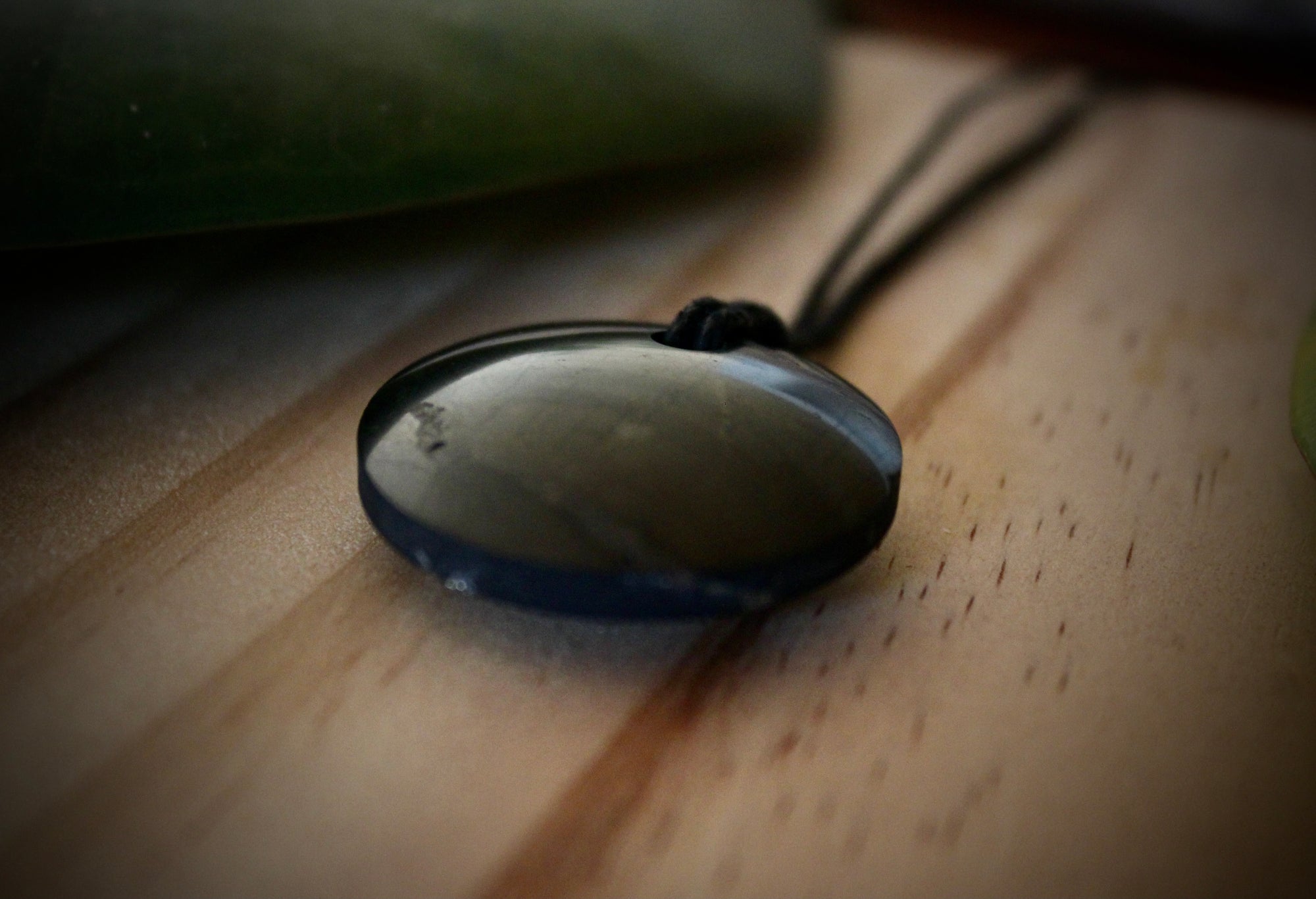 Shungite Sacred Circle Pendant - "Isis" (3cm), displaying unique markings and veins, crafted from genuine shungite stone.