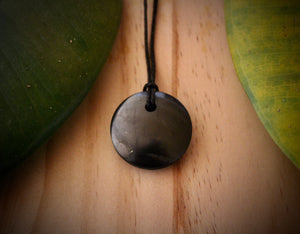 Shungite Sacred Circle Pendant - "Isis" (3cm), displaying unique markings and veins, crafted from genuine shungite stone.