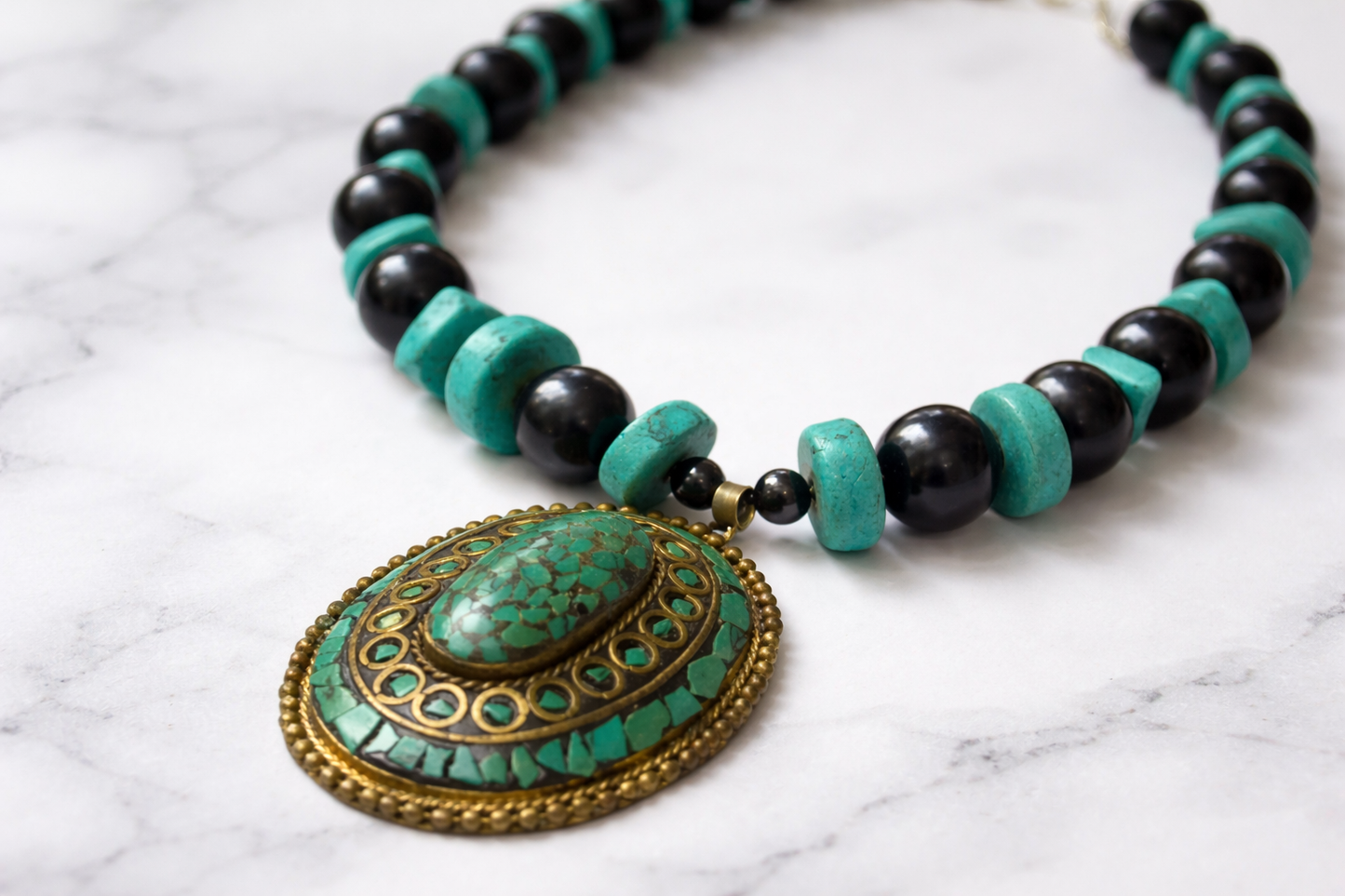 chunky turquoise pendant on a shungite and turquoise choker neckalce 
